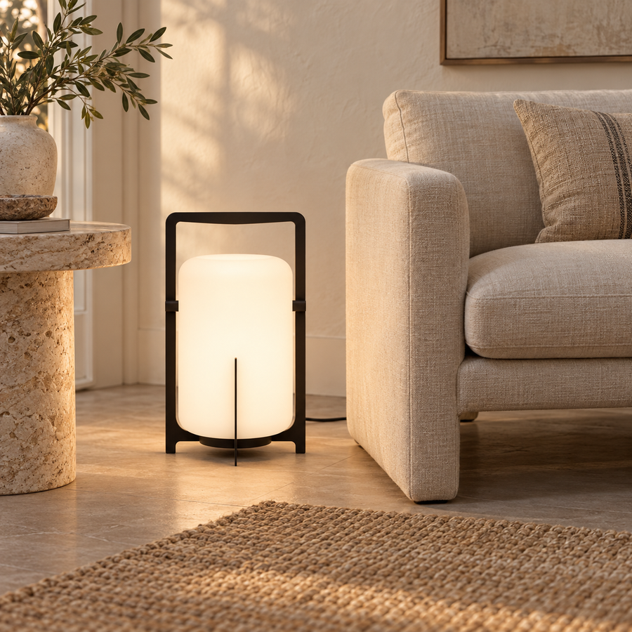 Stria — lanterne noire et opaline dans un salon, près d’un fauteuil